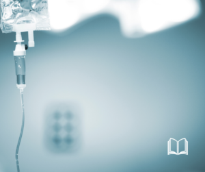 A single IV bag against a gray hospital background.
