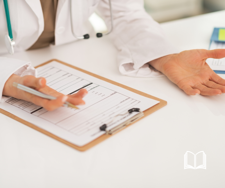A doctor's hand at a white desk overlooking a patient's chart.