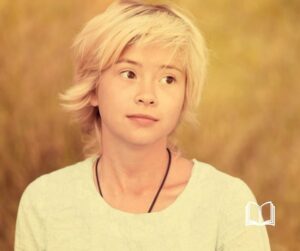 Blond Asian woman looking to the side with a curious expression.