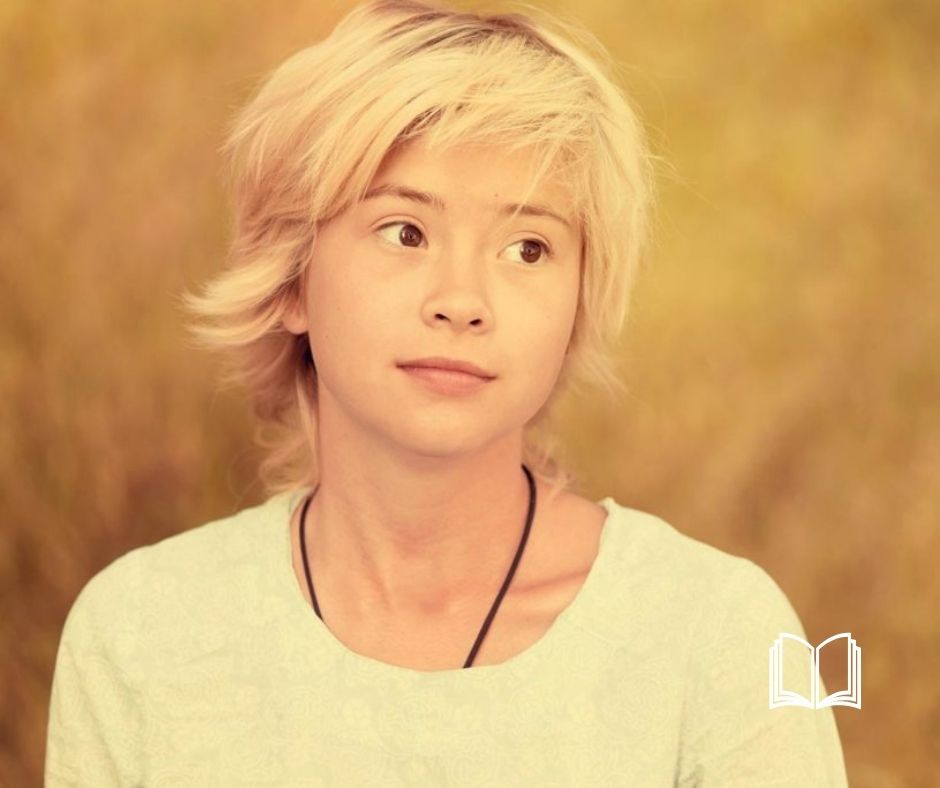 Blond Asian woman looking to the side with a curious expression.