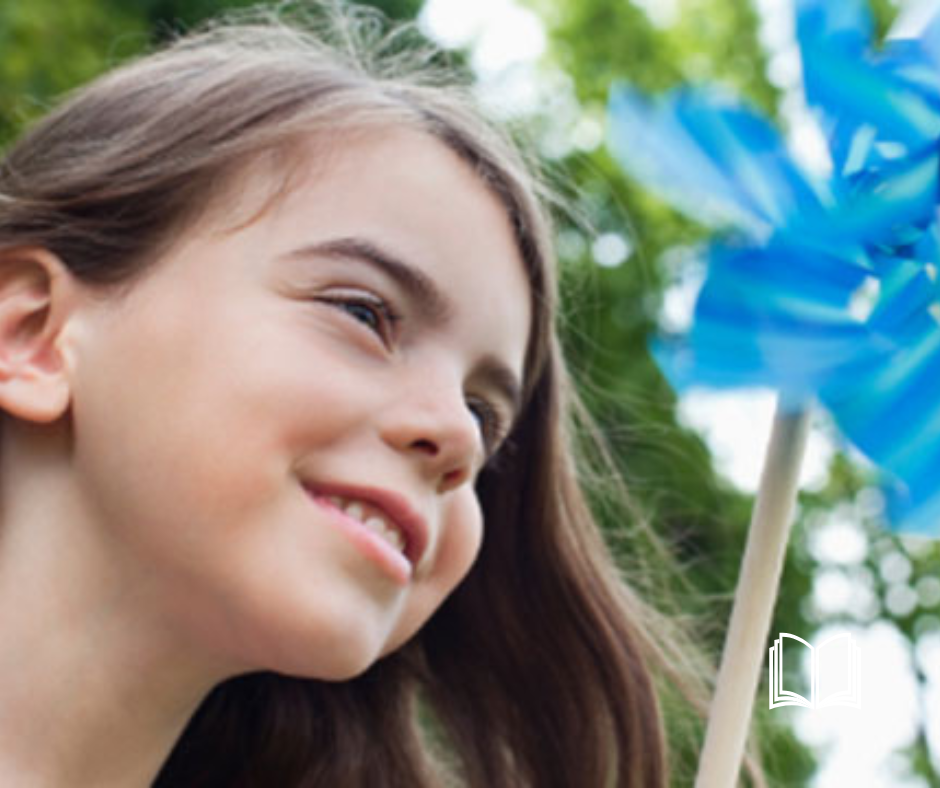Headshot of a little girl smiling.