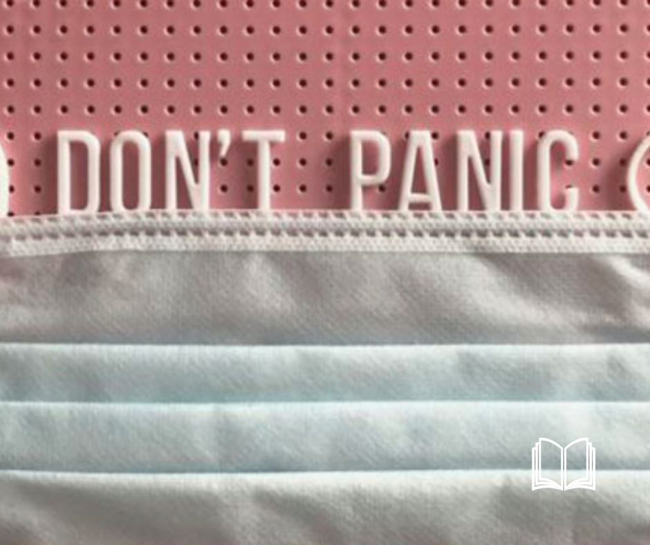 "Don't Panic" written on top of a mask.