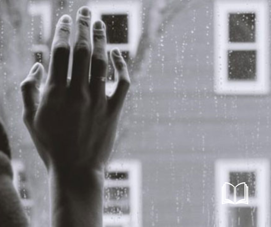 Greyscale hand placed delicately against a window.