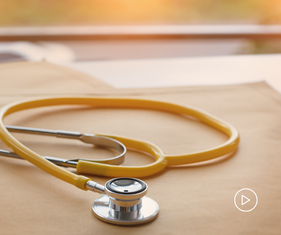 Light orange stethoscope on a wooden table.