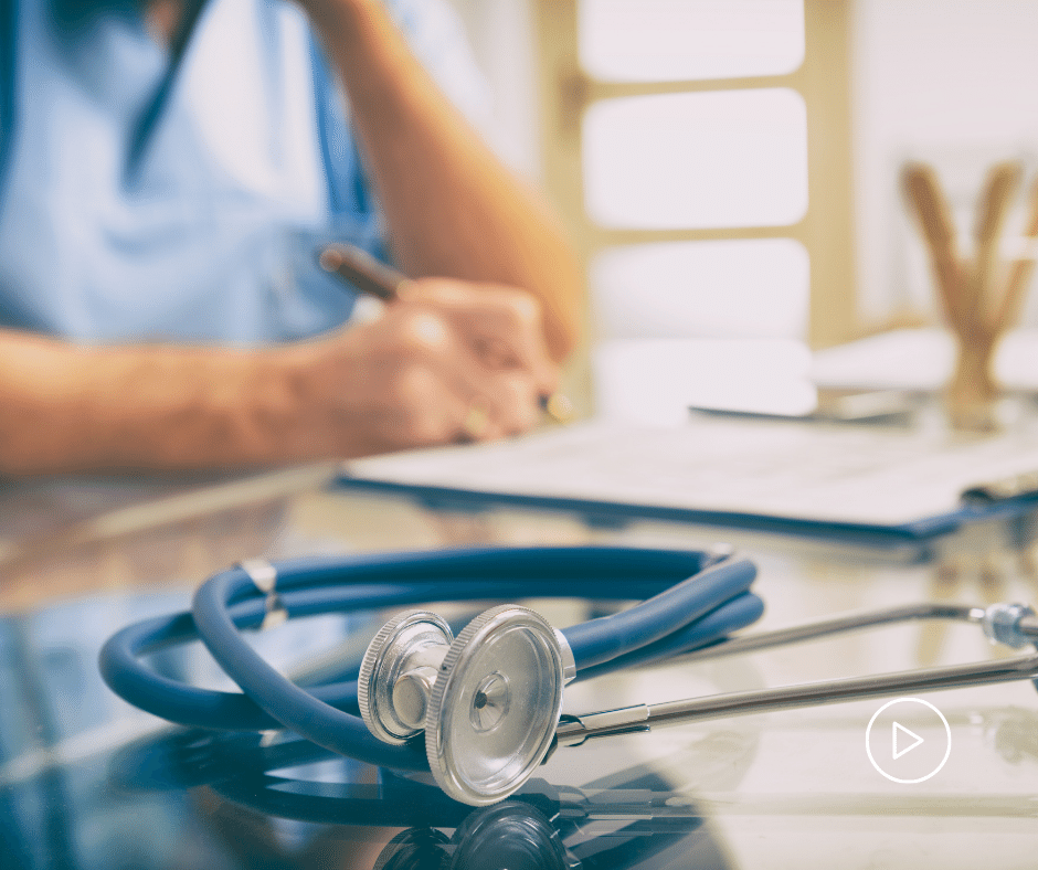 Doctor writing at a desk.