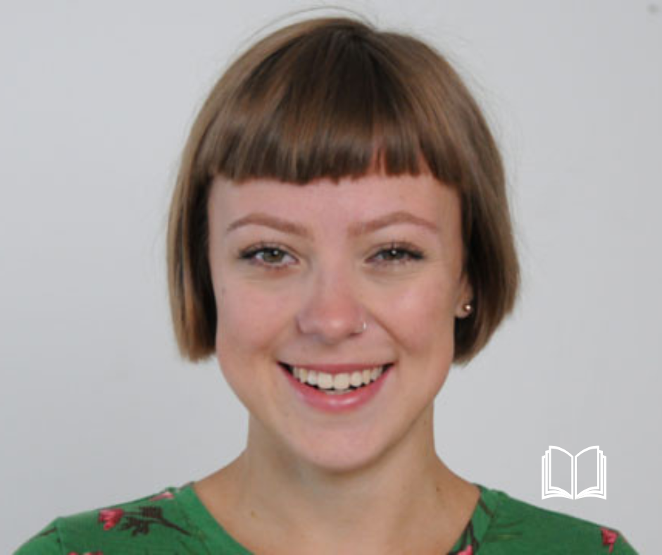 Headshot of a brunette woman smiling.