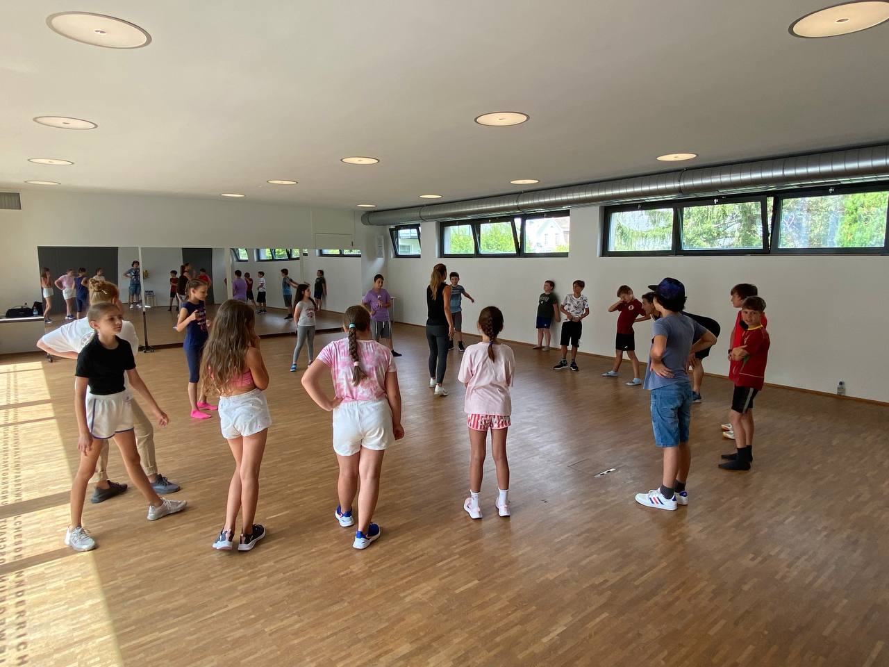 Children standing in a circle during a dance class.