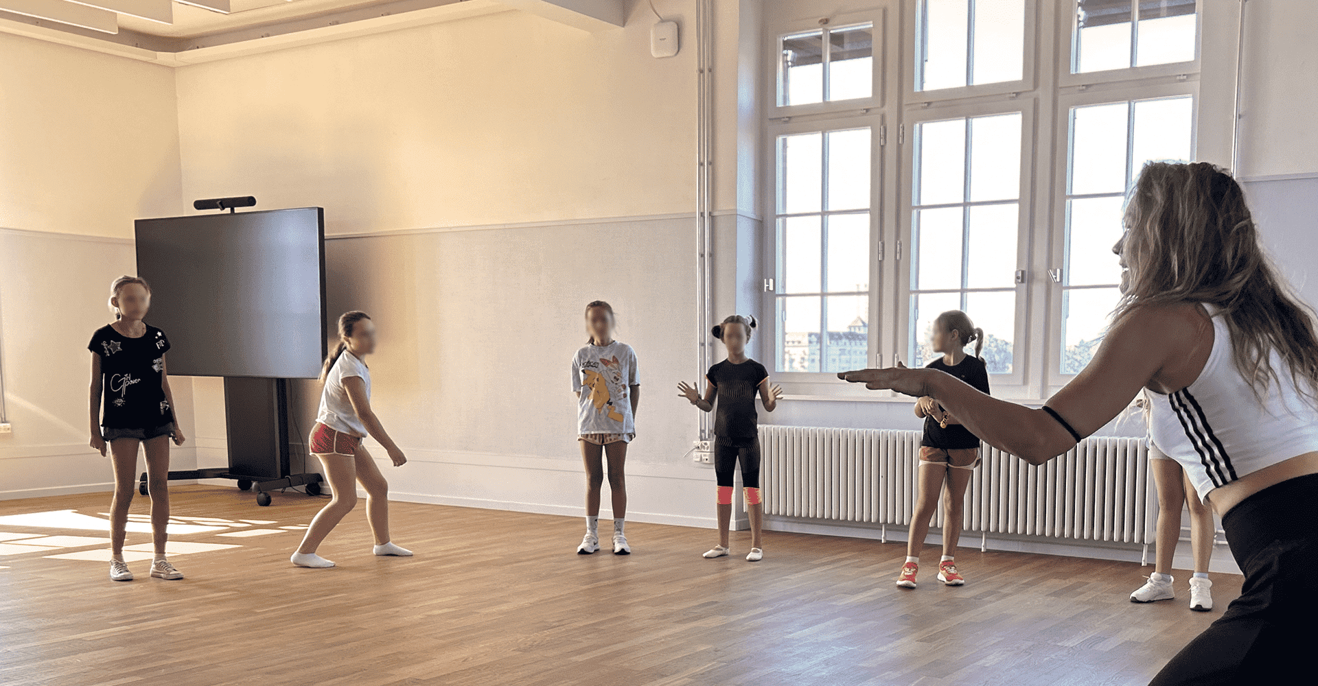 Instructor teaching a little girls' dance class.