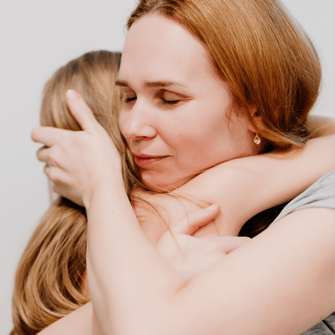 Mother hugging her Daughter.