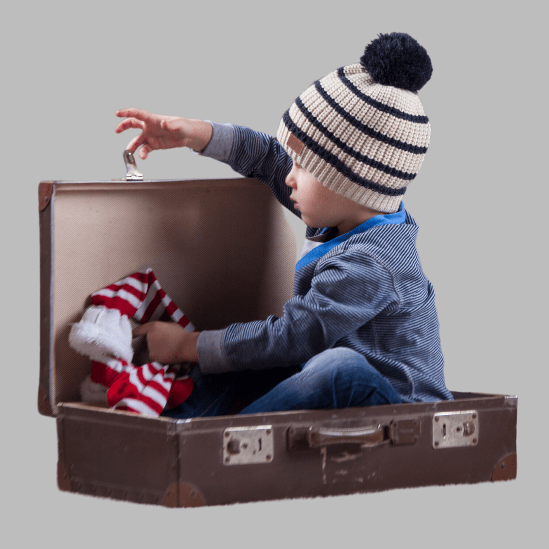 Toddler playing in a suitcase.