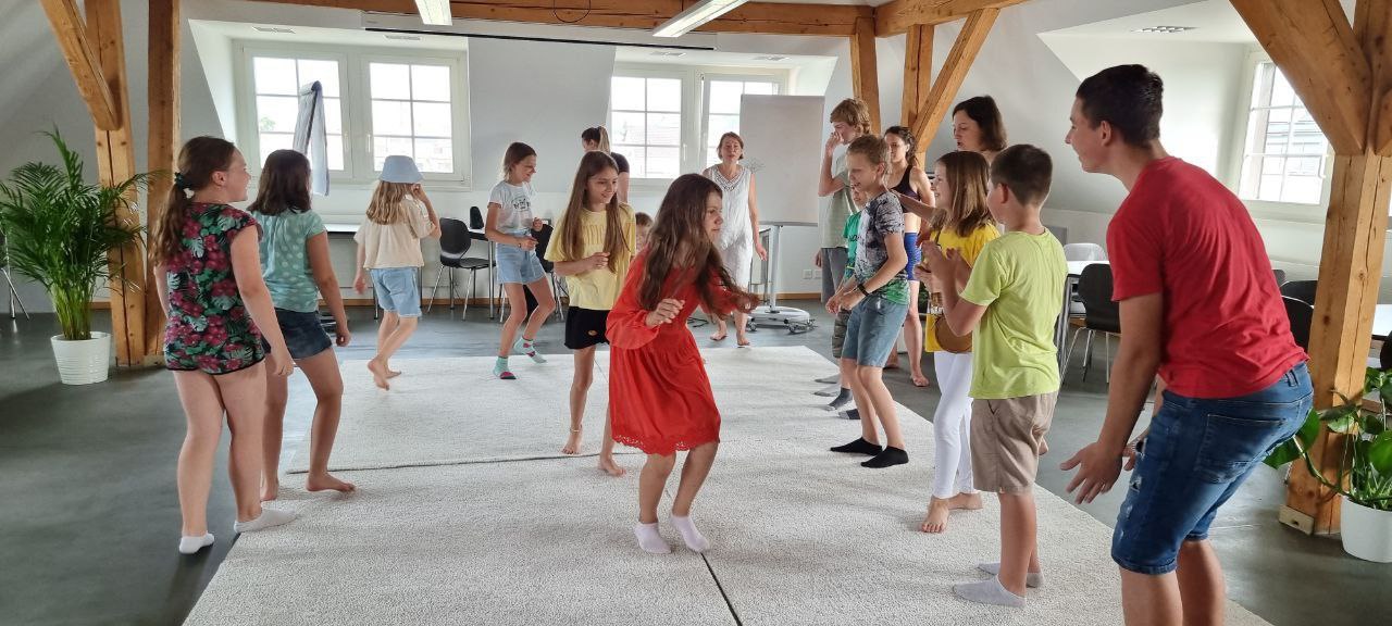 Children playing around a circle.