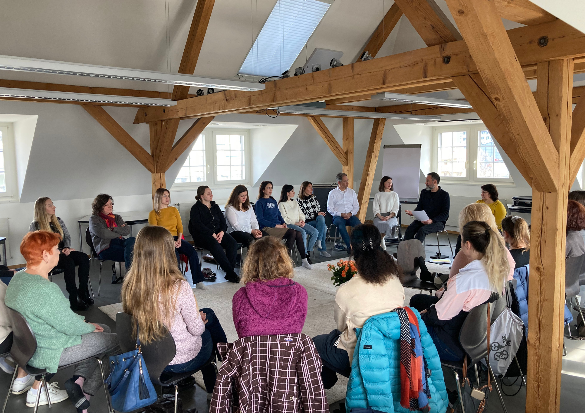 Meducare - Image of a meeting group sitting around a circle